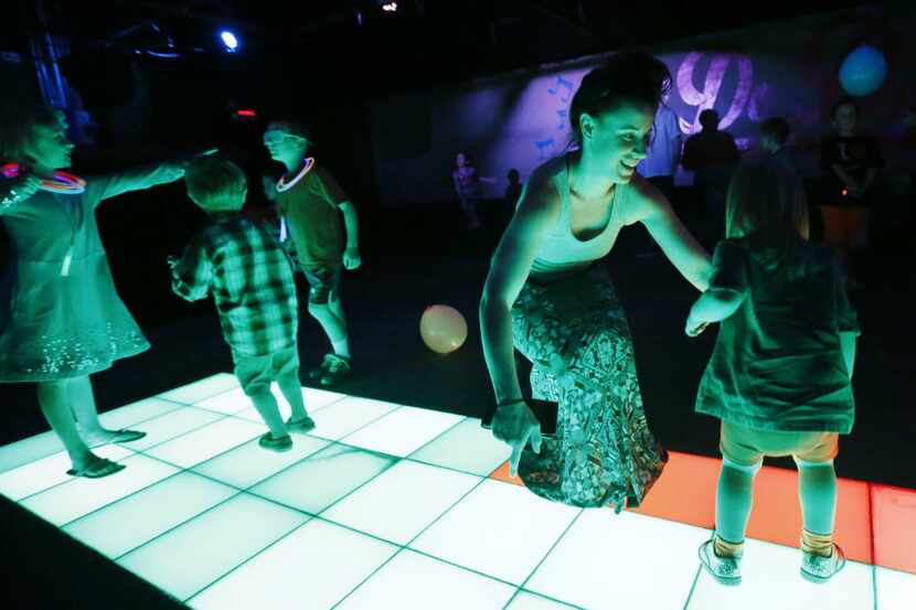 Dana Emch, second from right, dances with her two-year-old niece Rory Emch-Moog during Disco...