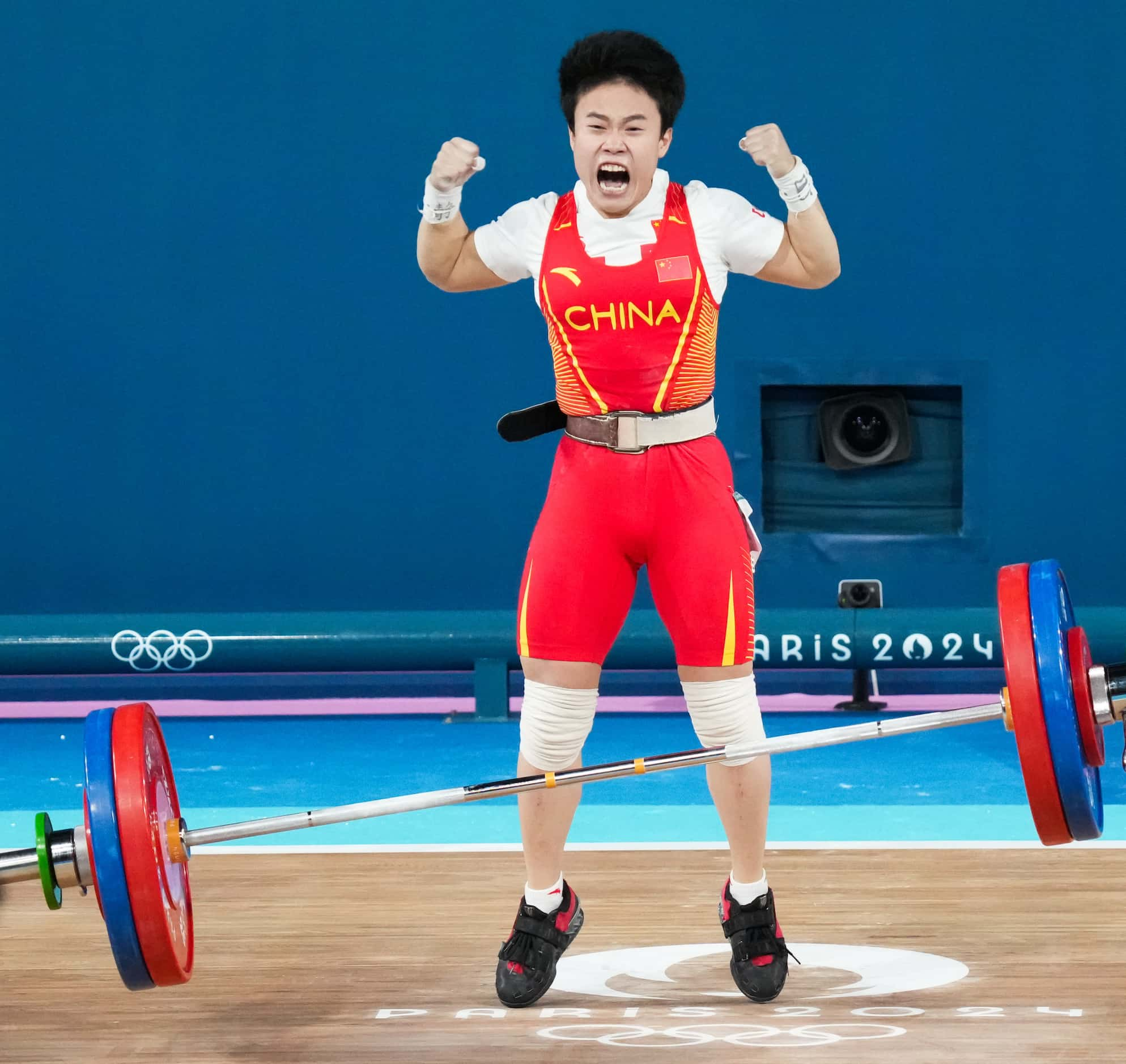 Hou Zhihui of China reacts after lifting 117kg, a new Olympic record, in the in the clean...