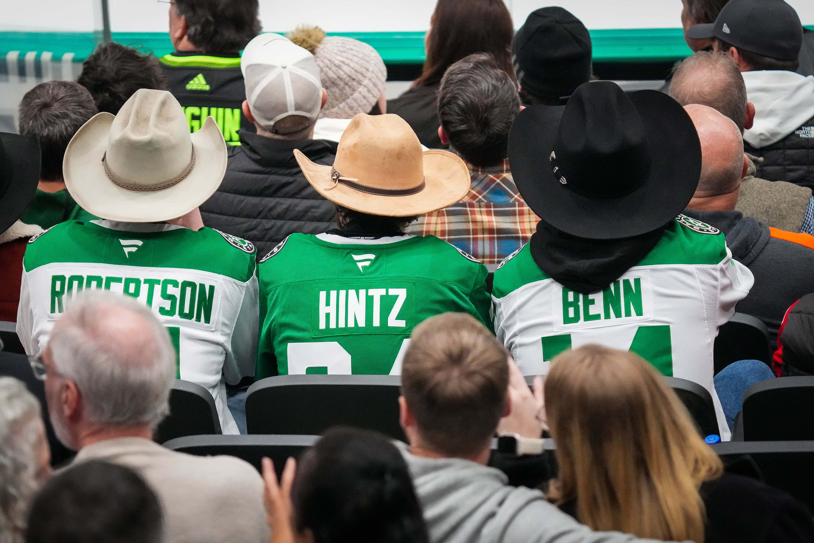 Dallas Stars fans wear the jerseys of Jason Robertson, Roope Hintz and Jamie Benn during the...