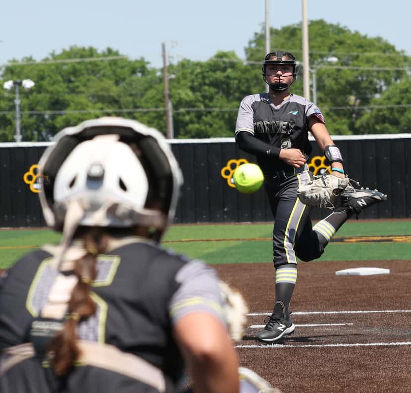 Forney pitcher Emmie Santos (21) delivers a pitch to a Prosper Walnut Grove batter during...