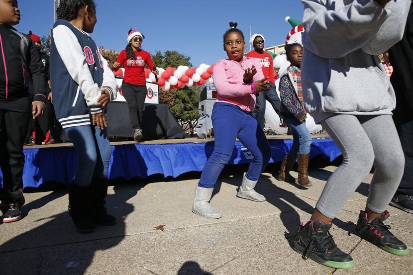 
Above: Powerhouse Entertainment leads revelers in a dance. 
