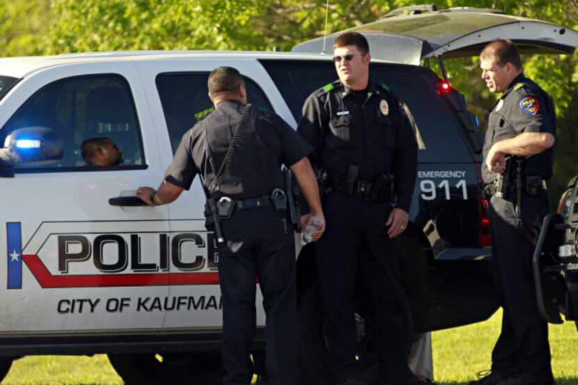 Kaufman police officers manned a roadblock Friday as officials searched the home of Eric...