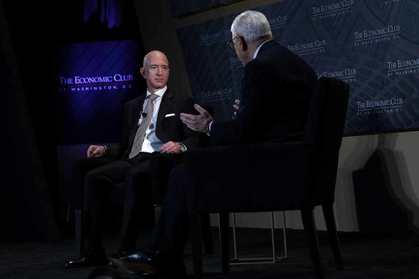 CEO and founder of Amazon Jeff Bezos (left) participates in a discussion with president of...