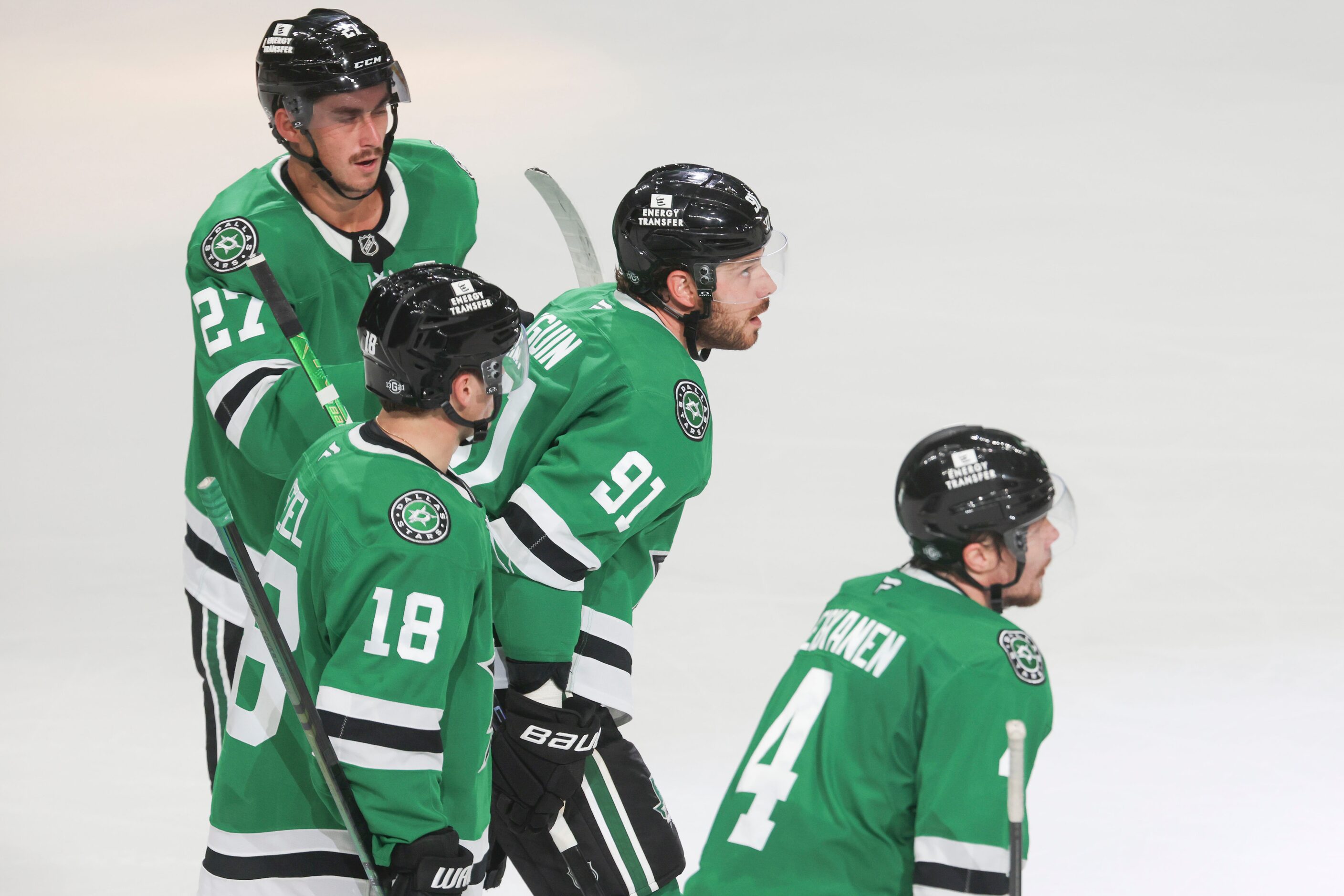 Dallas Stars center Tyler Seguin (center) gets congratulated by center Sam Steel (18) and...