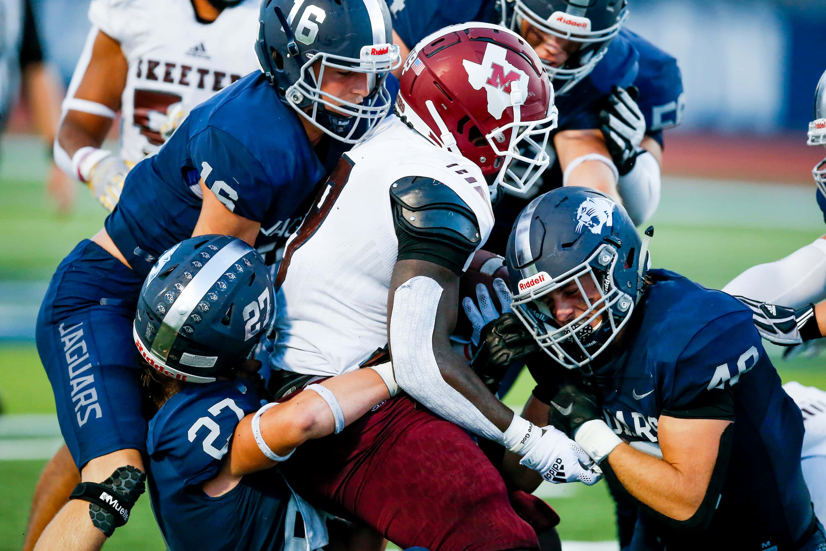 Mesquite senior running back Anthony Roberts (19) is tackled by the Flower Mound defense...
