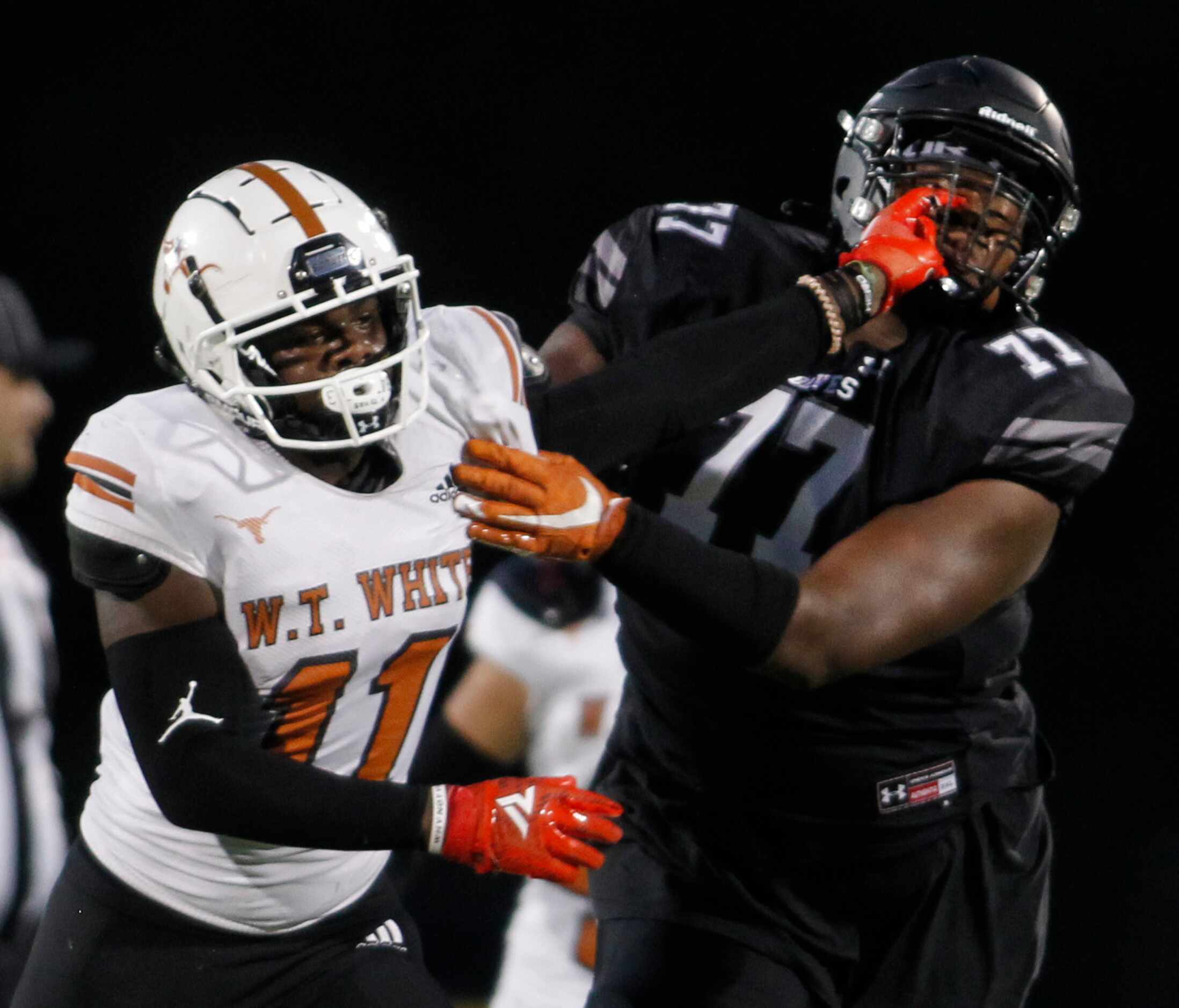 W.T. White linebacker Markavious Justice (11), left,  stiff-arms Mansfield Timberview...