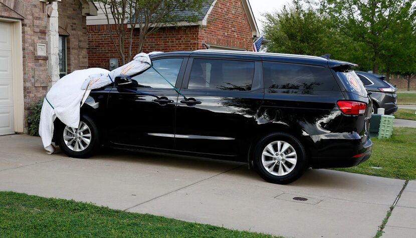 Residents in McKinney prepare their cars for possible hail  as the threat of storms get...