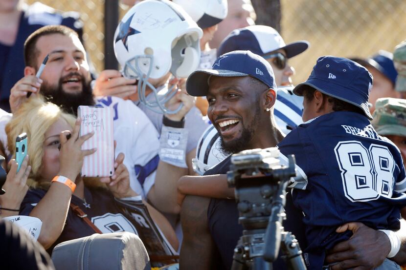 Dallas Cowboys wide receiver Dez Bryant (88) holds a crying Joshua Williams, 9, after he...