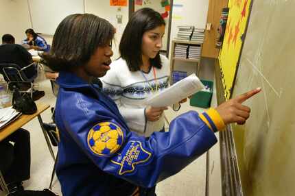 In 2004, Lakeview Centennial High School junior Adrienne Reese, front, helps fellow AVID...