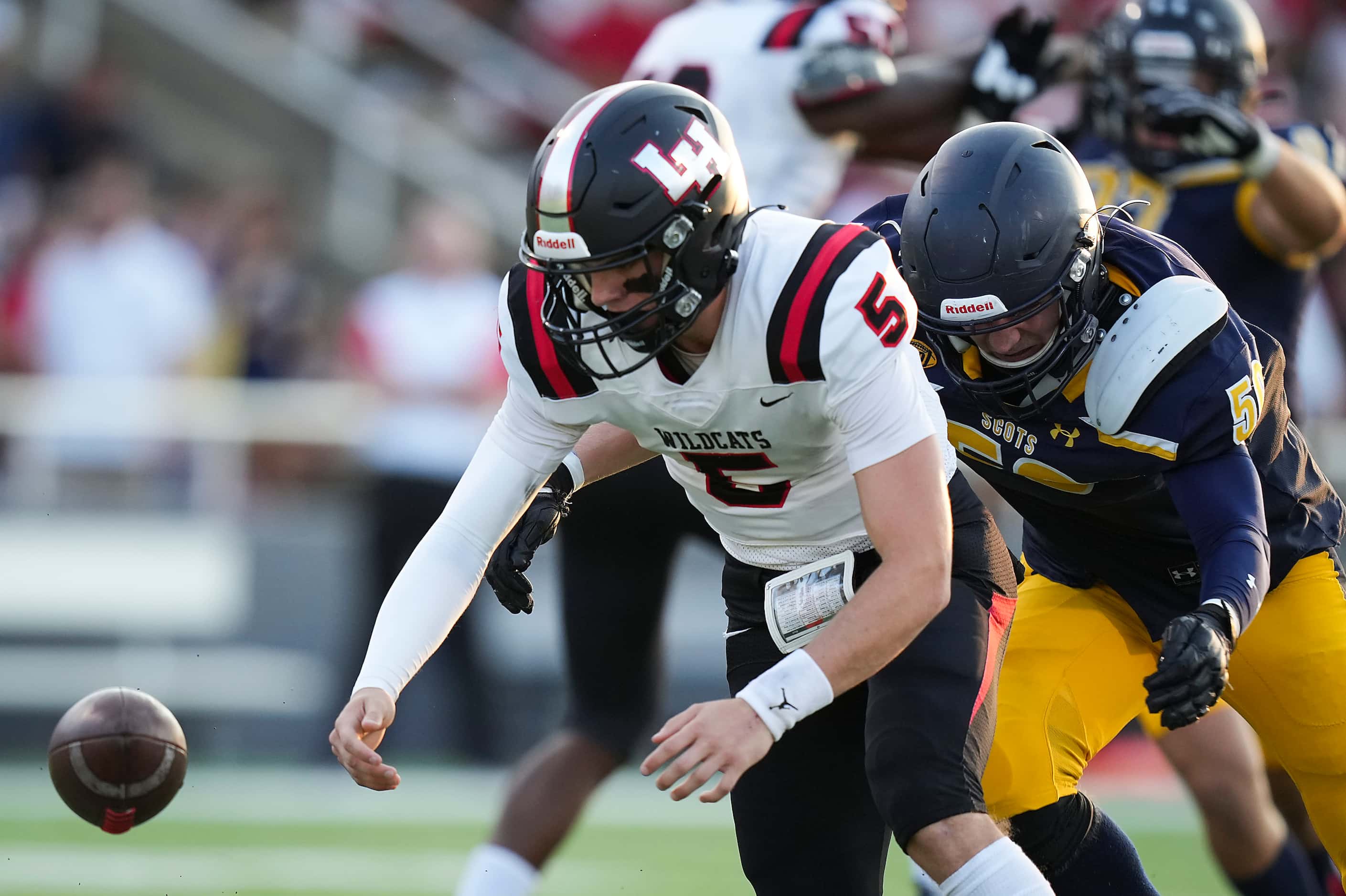 Lake Highlands quarterback Tripp Holley (5) loses the football as Highland Park defensive...