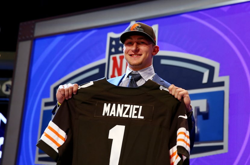 NEW YORK, NY - MAY 08:  Johnny Manziel of the Texas A&M Aggies poses with a jersey after he...