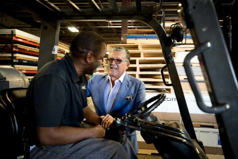 Wayne Gono, visionary/chief networking officer of Regal Plastics, talks to employee Vernon...