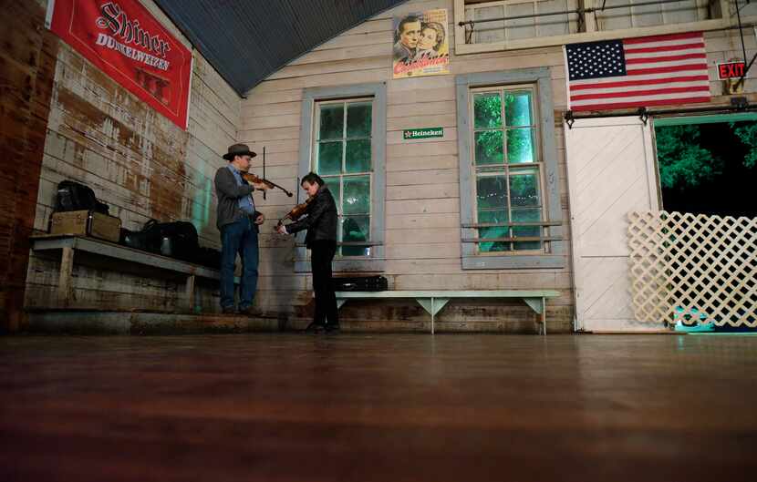 In this Dec. 6, 2014, photo, fiddlers perform at Twin Sisters Dance Hall in Blanco, Texas. A...