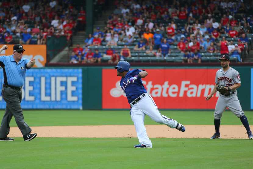 ARLINGTON, TX - AUGUST 13: Jose Altuve #27 of the Houston Astros looks on as umpire Bill...