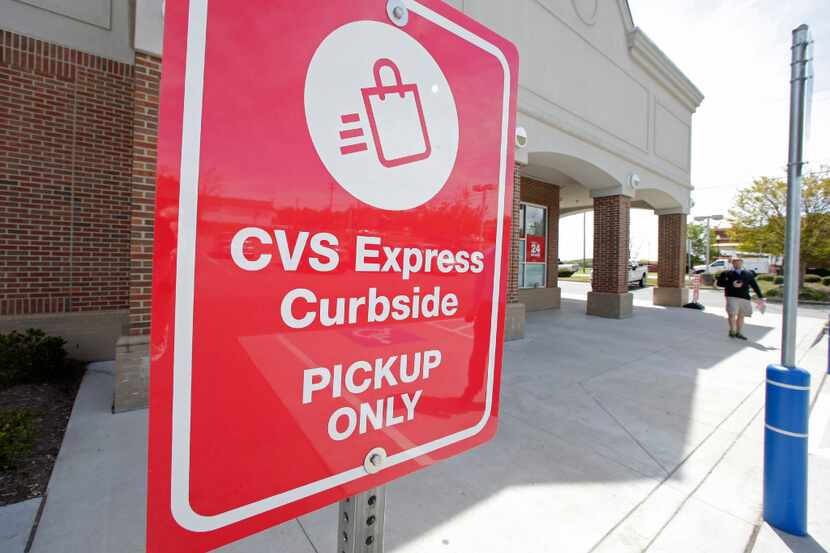 This April 15, 2016, photo shows a CVS Express parking sign at a CVS store in Harrisburg,...