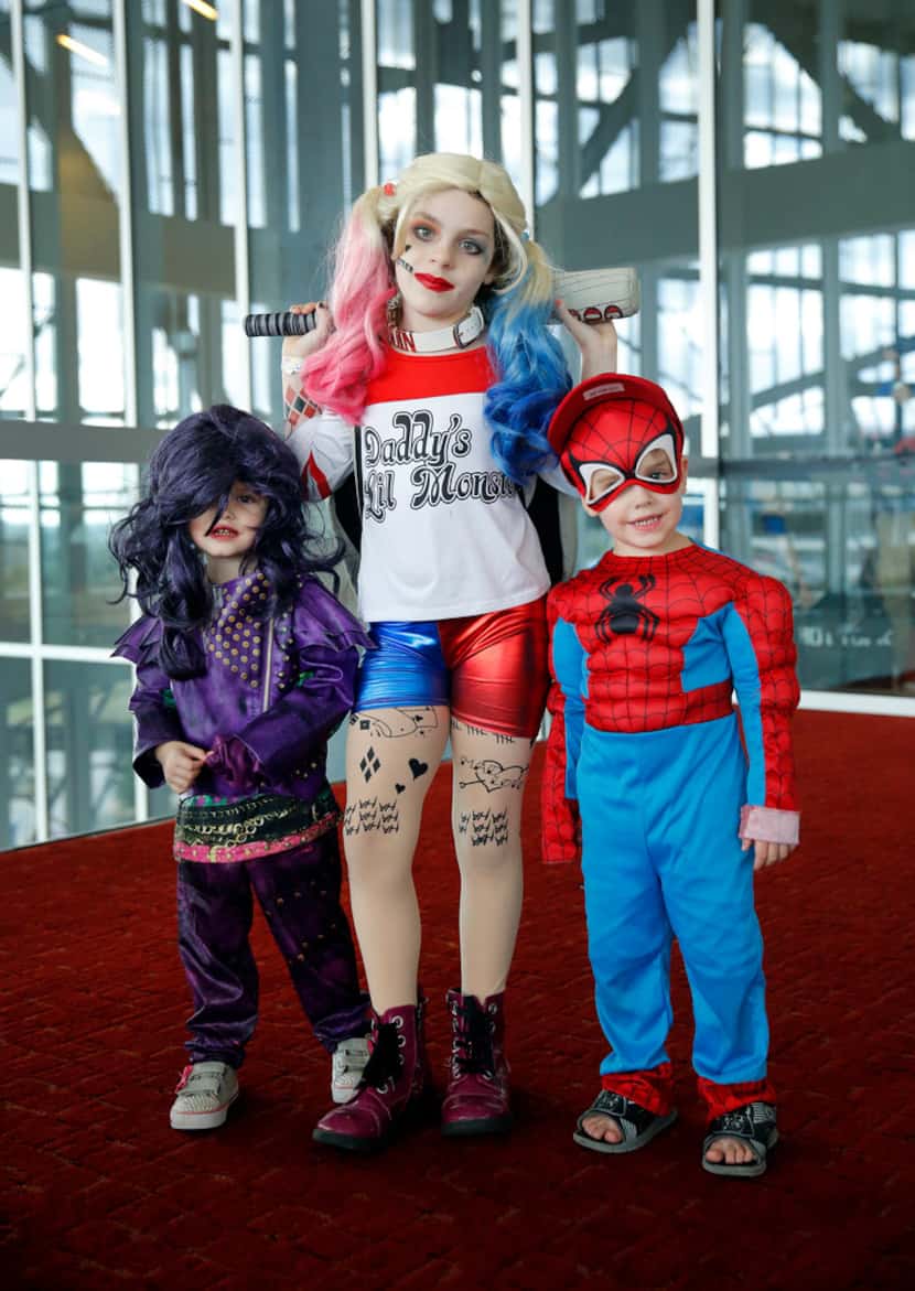 Dressed as Harley Quinn of Suicide Squad, Emily Pearson of Euless (center) poses with her...