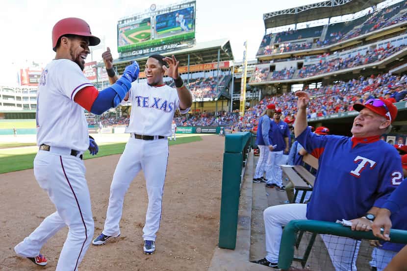 There are smiles all around as Texas Rangers catcher Robinson Chirinos (61) is greeted at...