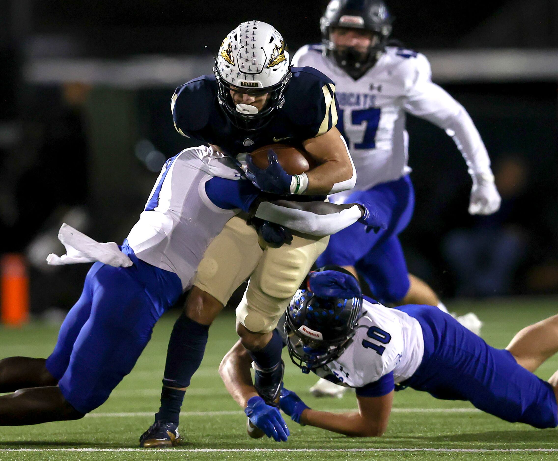 Keller running back Austin Coleman (c) is stopped for a short gain by Byron Nelson defensive...