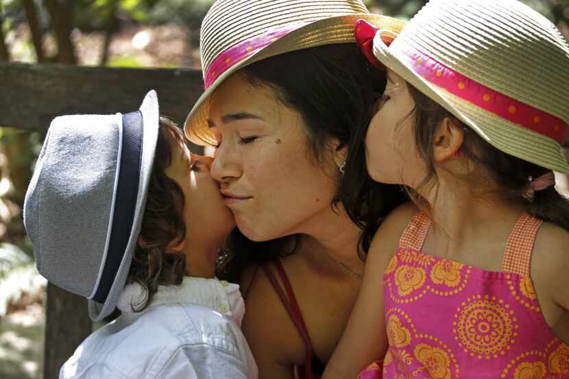 Danielle Petchesky of Grapevine, center, gets some love from her children Jack, left, and...