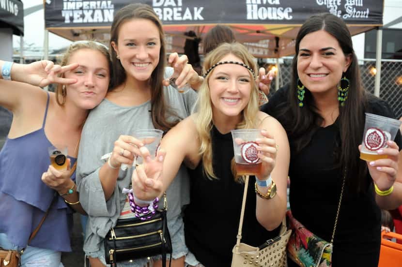 Friends drink craft beer at Untapped Festival in Fort Worth, TX on May 9, 2015.