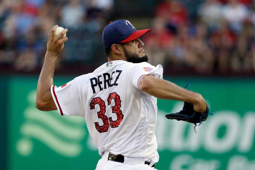 Texas Rangers' Martin Perez (33) throws to the Boston Red Sox in the first inning of a...