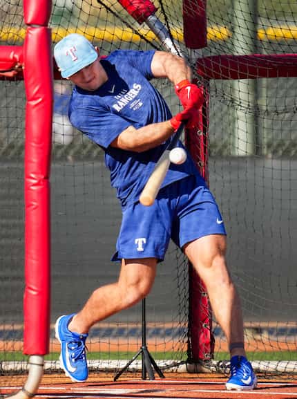 Texas Rangers outfielder Wyatt Langford takes batting practice during a spring training...