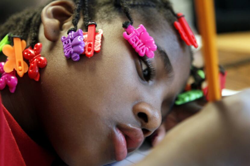 Myvonjayla Davis writes a letter to her father, part of an assignment in her first-grade...