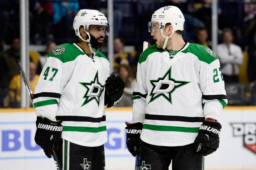 Dallas Stars defenseman Johnny Oduya (47), of Sweden, and center Colton Sceviour (22) talk...