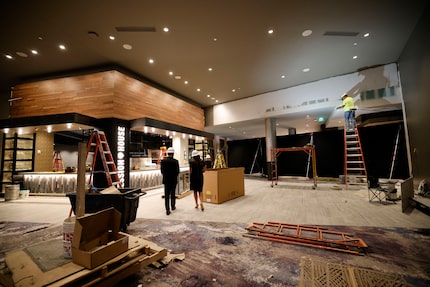  A construction worker, far right, works inside the Lucas Oil Live at WinStar World Resort...