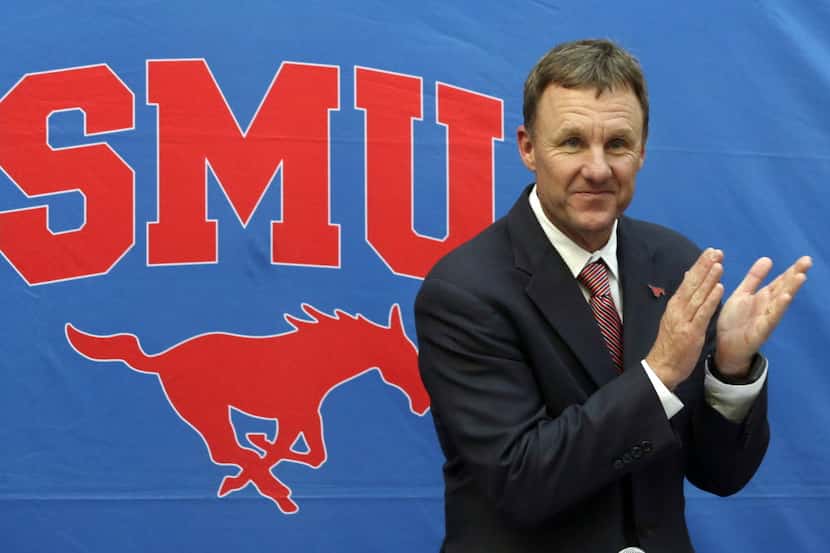 New SMU head football coach Chad Morris claps before being introduced during a news...