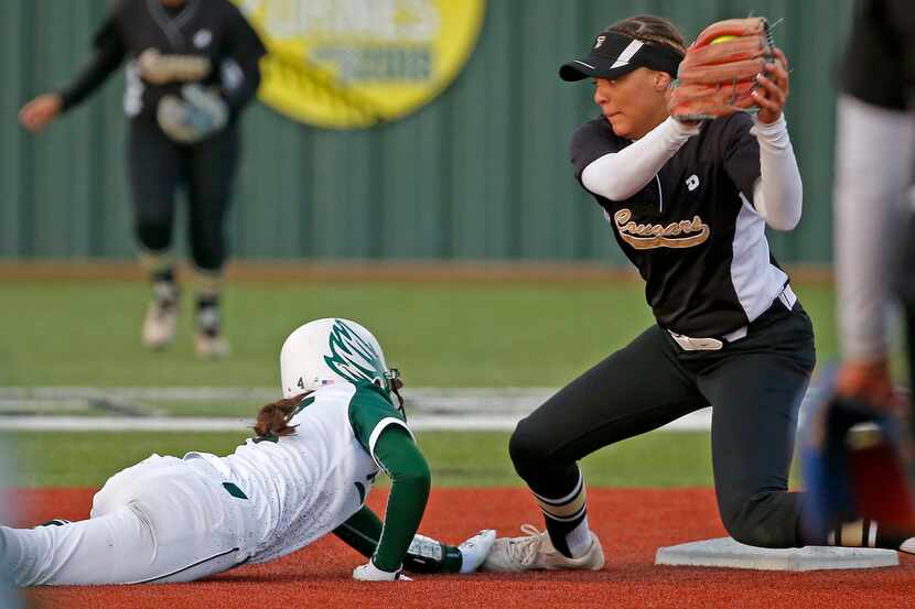 Prosper runner Jessica Malan, left, slides safely back to second in a pickoff as The...