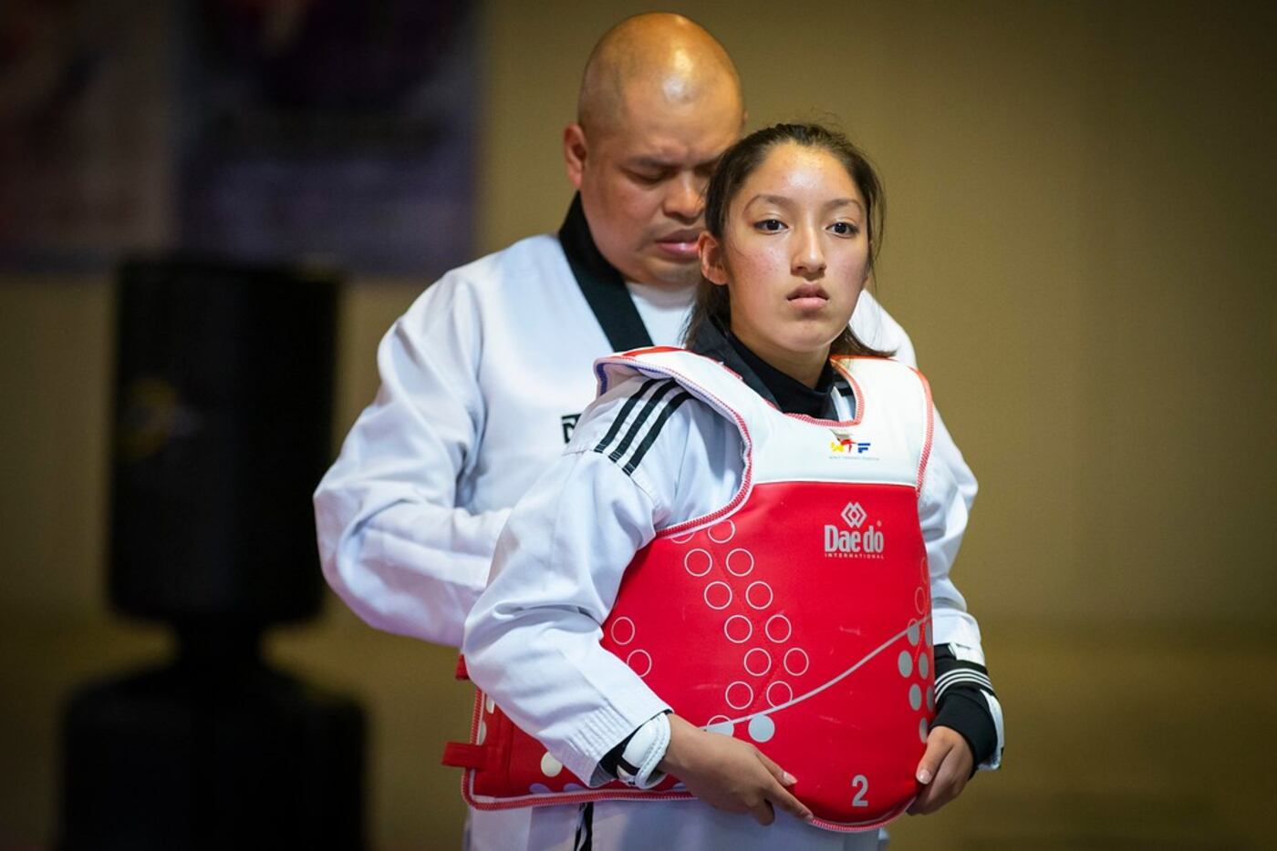 Karla Montoya is assisted by Julio Baltazar as she prepares to spar during training at Lee's...