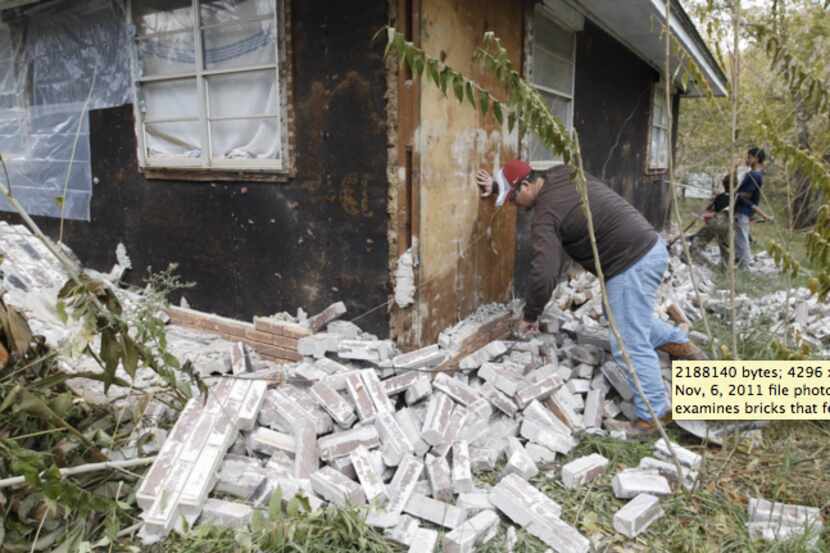 In this Nov, 6, 2011 file photo, Chad Devereaux examines bricks that fell from three sides...