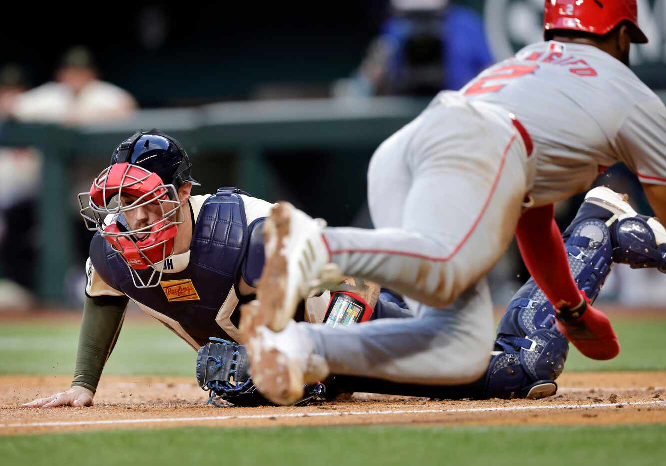 Los Angeles Angels second base Luis Rengifo dives safely at home plate on an overthrown ball...