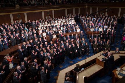 Republicans applaud as most Democrats remain seated as President Donald Trump addresses a...