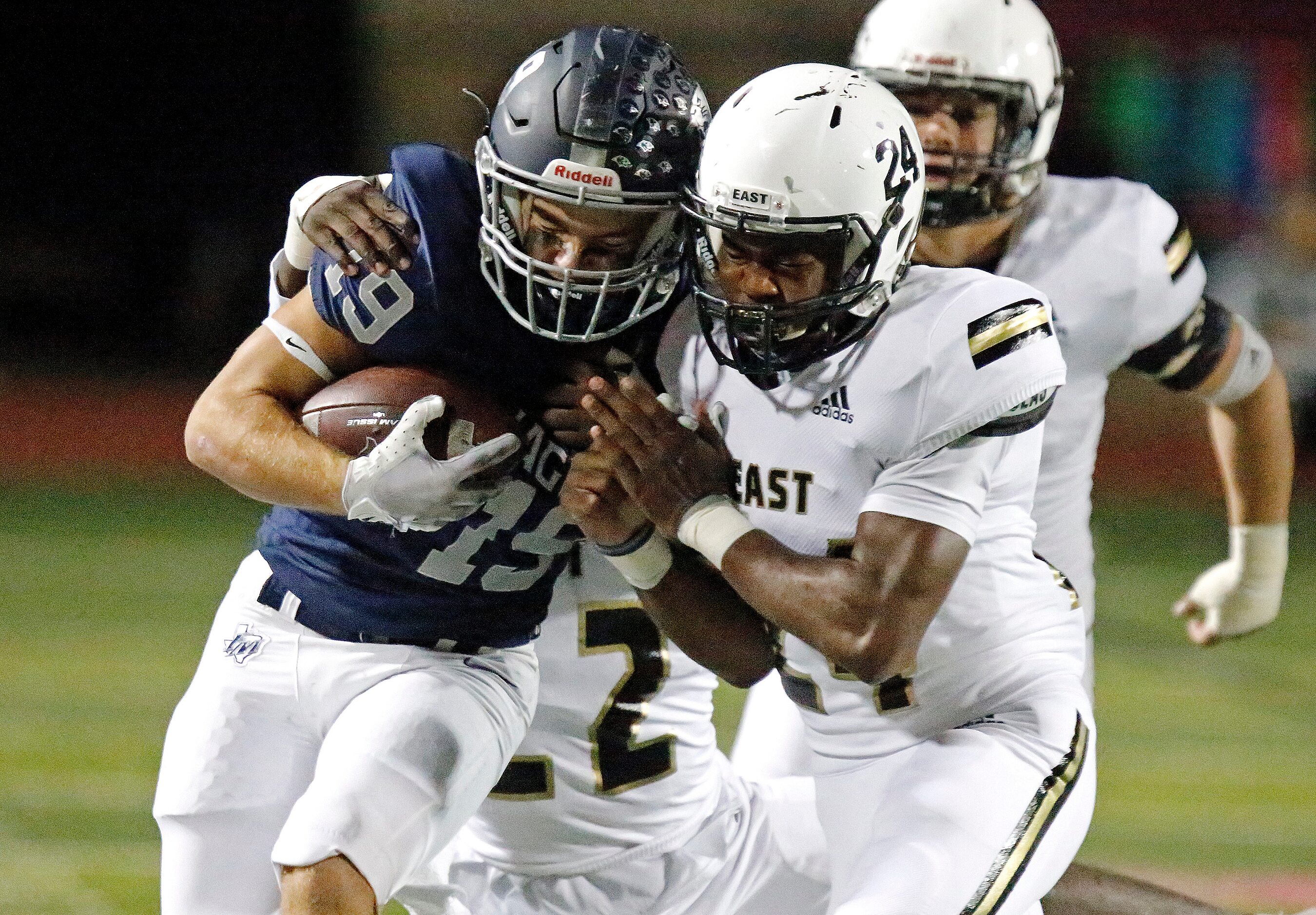 Flower Mound High School wide receiver Cade Edlein (19) collides with Plano East High School...