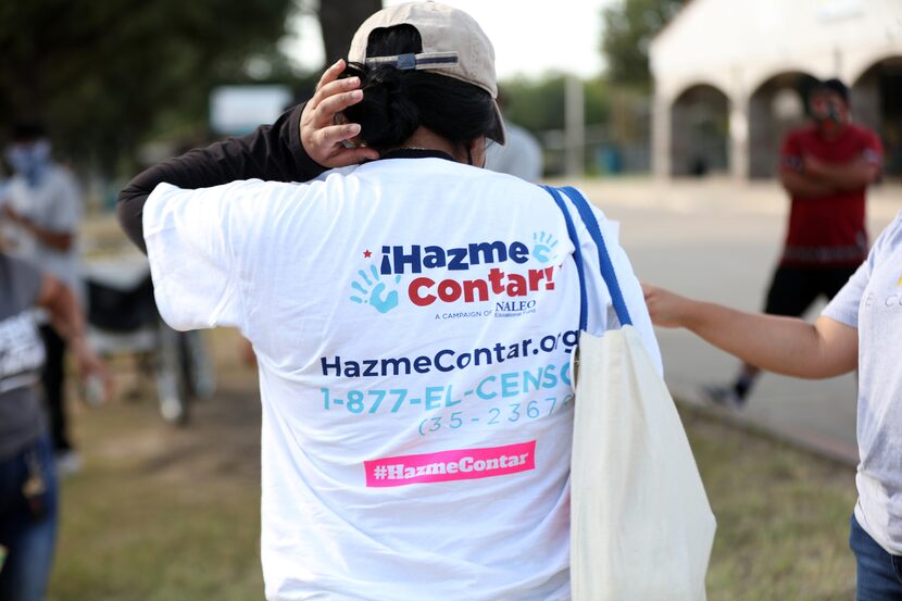 A Census Project volunteer in Dallas wears a T-shirt with a message inviting residents to be...