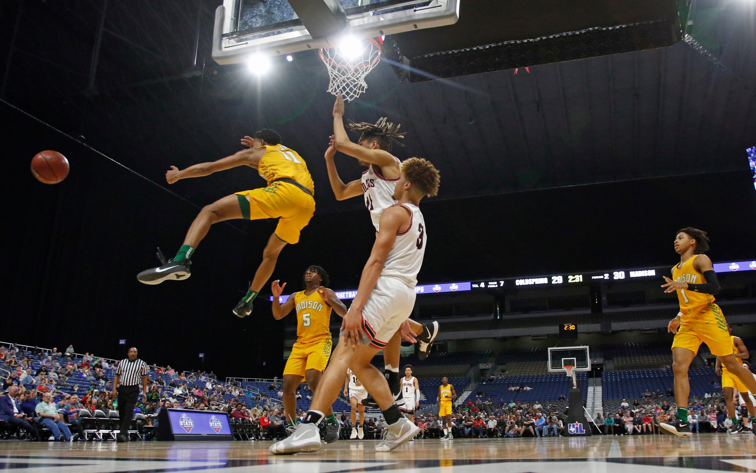 Madison guard Jerome Rogers Jr. #11passes off after driving the lane. Madison defeated...