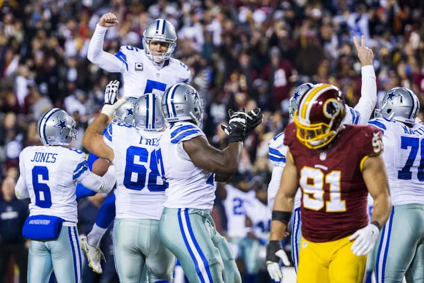 Dallas Cowboys kicker Dan Bailey (5) is lifted up by his team mates after scoring the game...