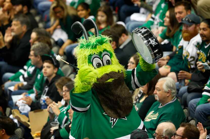 Dallas Stars mascot Victor E. Green beats the drum to get fans fired up in the second period...