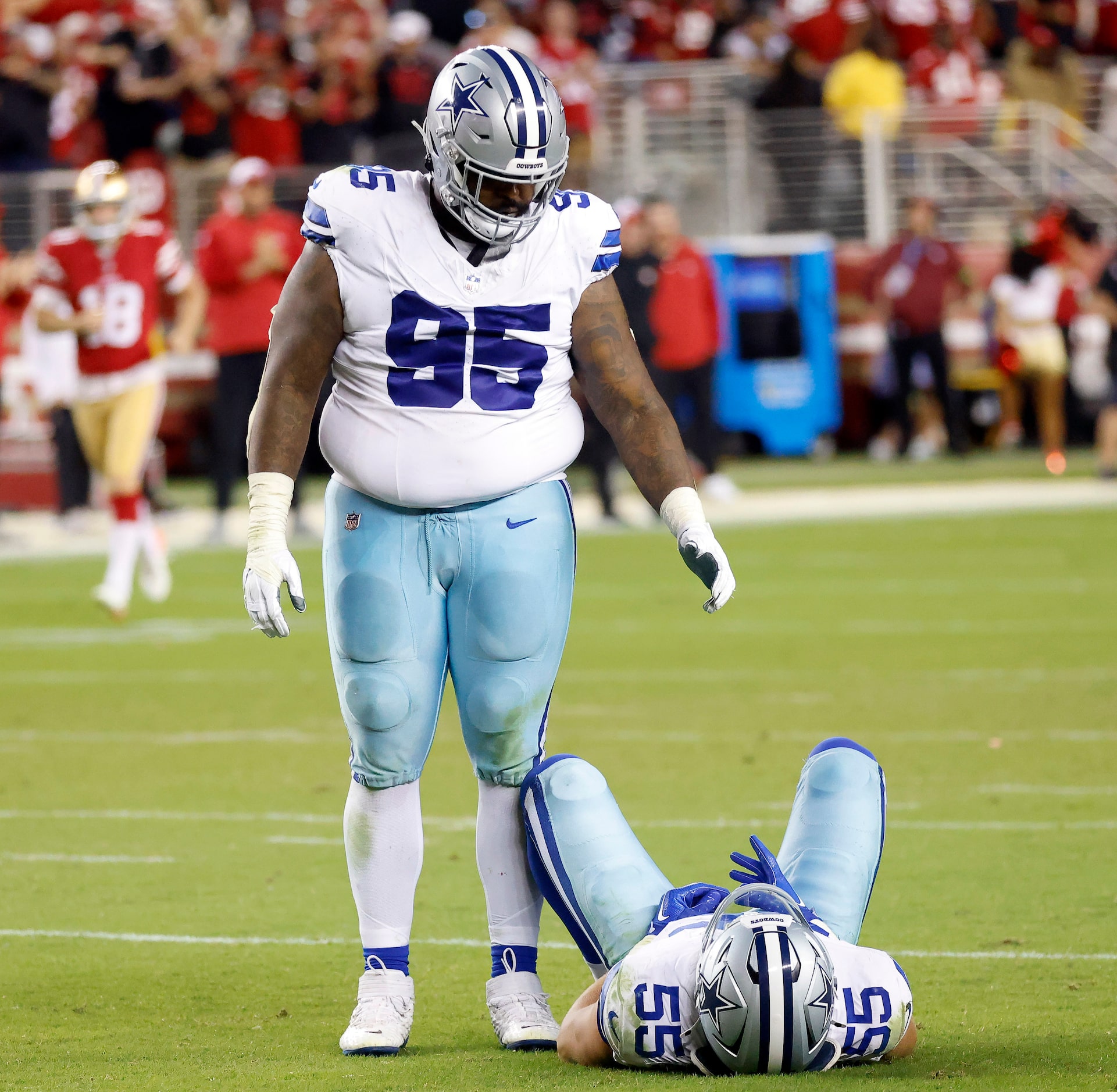 Dallas Cowboys defensive tackle Johnathan Hankins (95) stands over injured linebacker...