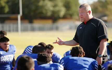 South Garland's head football coach Josh Ragsdale talks to his players after practice at...