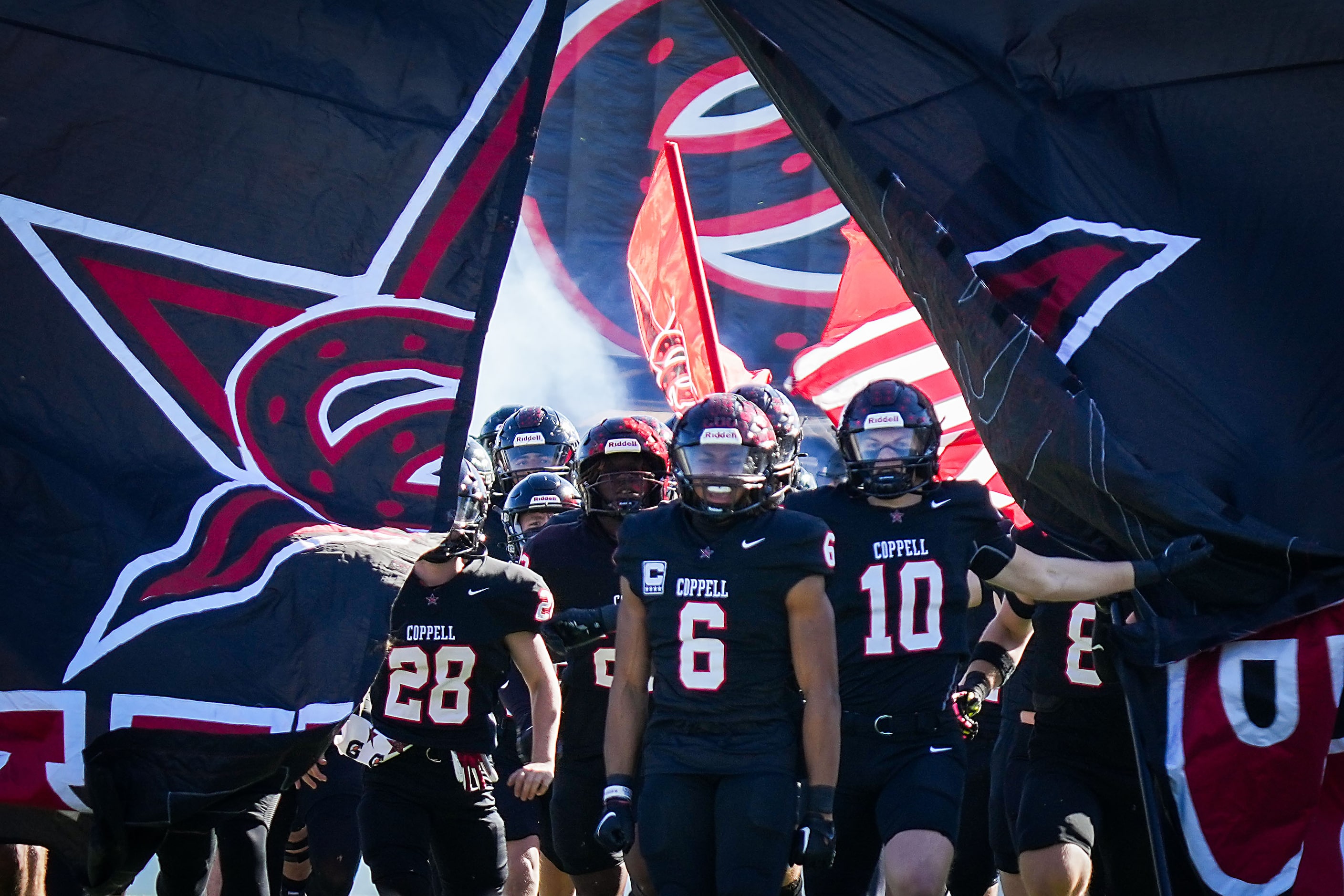 Coppell running back O'Marion Mbakwe (6) and defensive back Alexander Kraus (10) lead their...