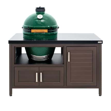 Big Green Egg grill placed inside dark brown table with hole for grill and cabinets