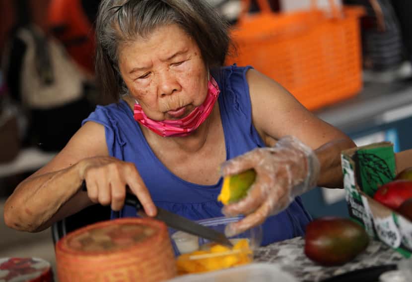 Wanna Chen prepares sweet sticky rice with mango during the Sunday Thai Food Market.