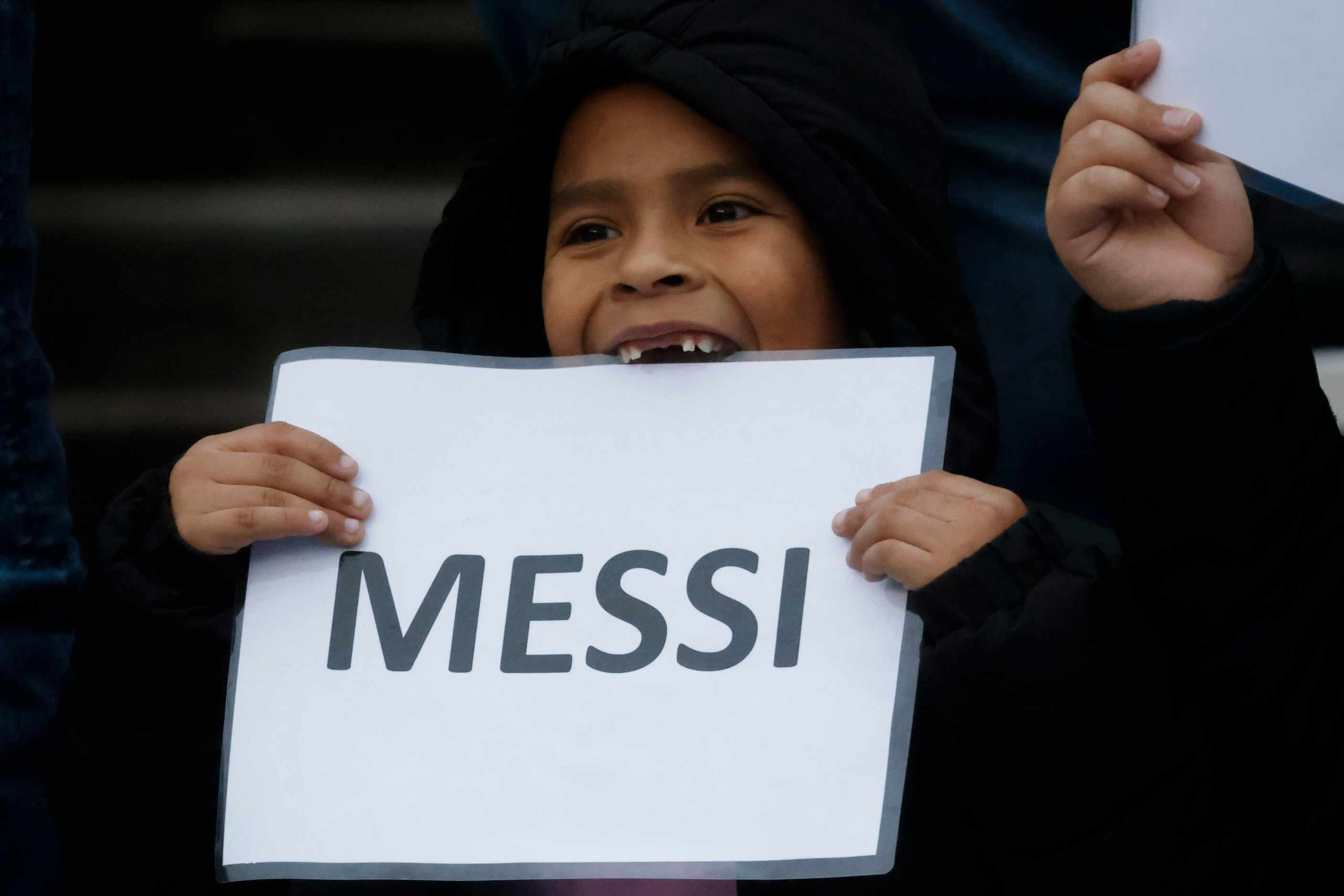 A young fan holds a sign of Inter Miami forward Lionel Messi during the first half of a...