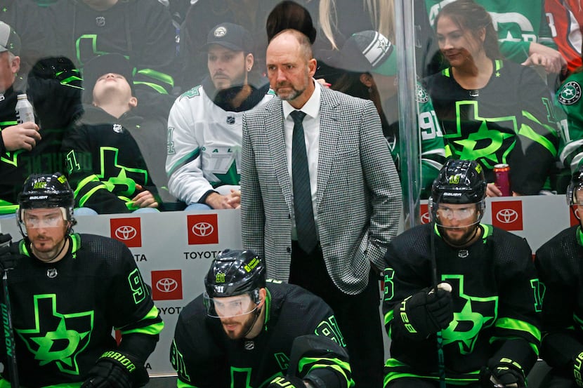 Dallas Stars head coach Peter DeBoer watches his players during the second period of an NHL...