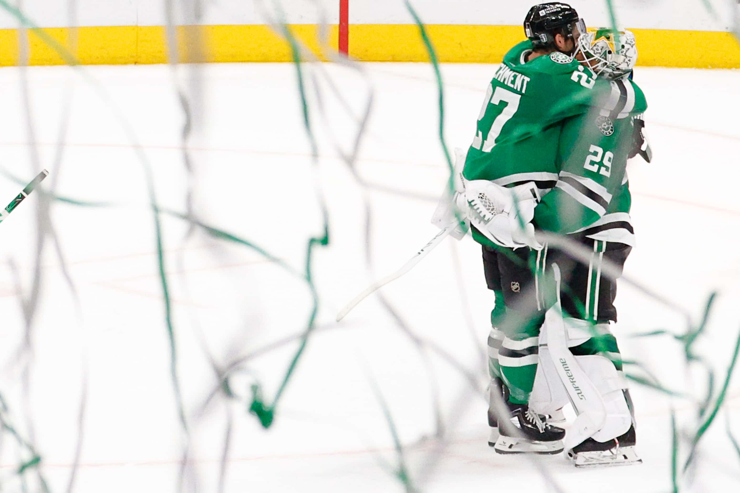 Dallas Stars left wing Mason Marchment (27) hugs goaltender Jake Oettinger (29) after their...