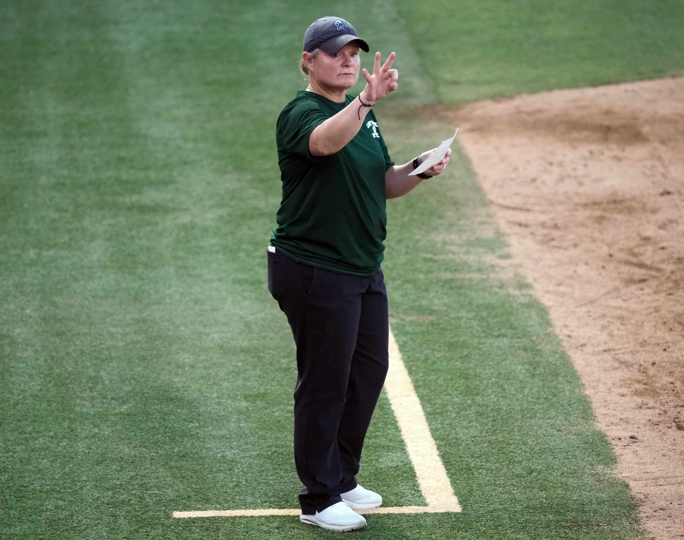 Mansfield Lake Ridge head coach Bobbi Cruff signals her batter against Northside O’Connor in...