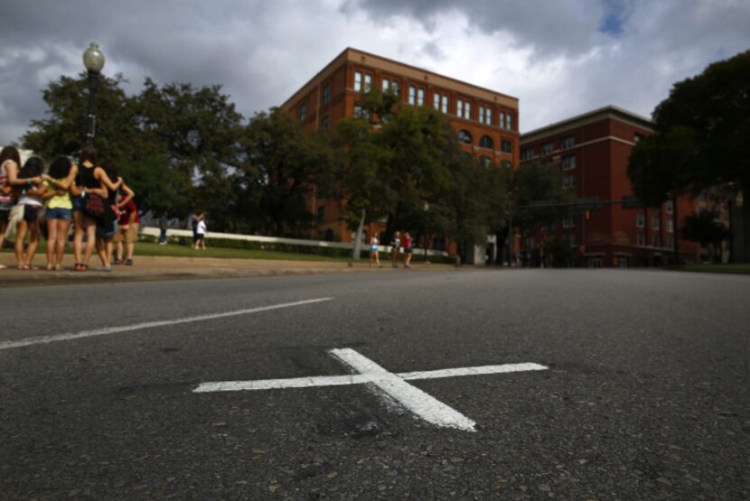 An “X” painted unofficially on Elm Street is intended to mark where President John F....